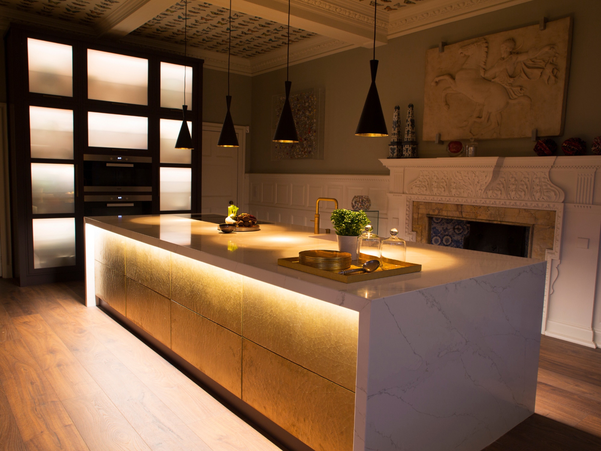 Modern kitchen island with mood lighting and bronze panelling